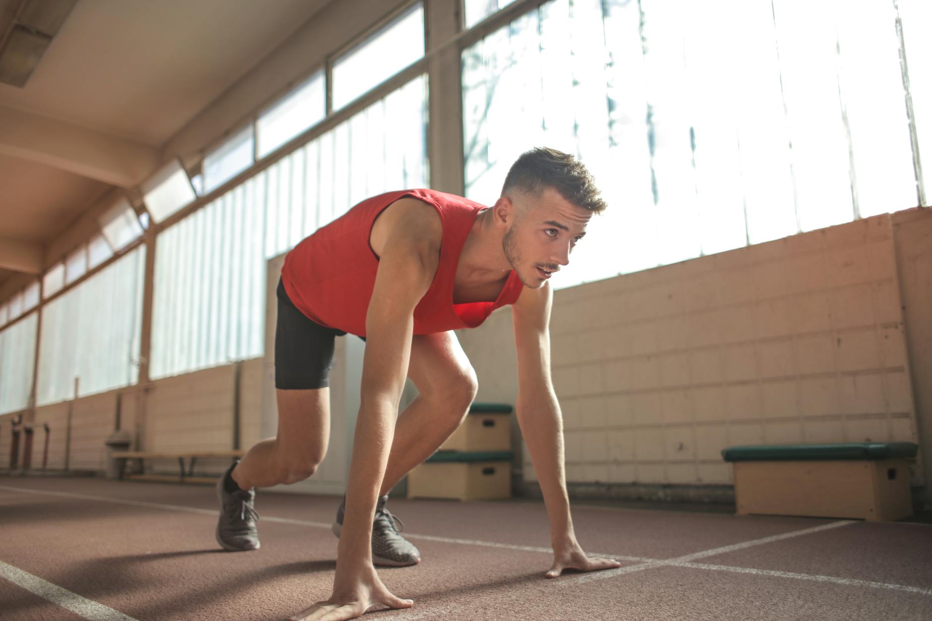 man in red tank top is about to run